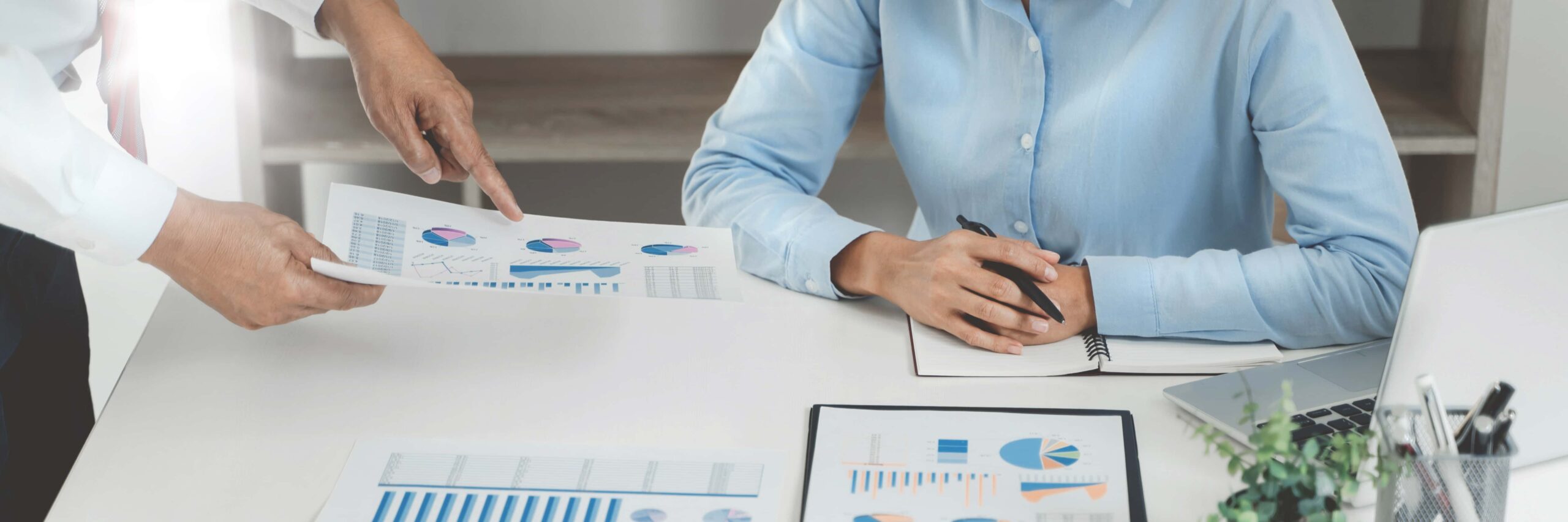 Business sales consultant discussing in data documents at modern office scaled