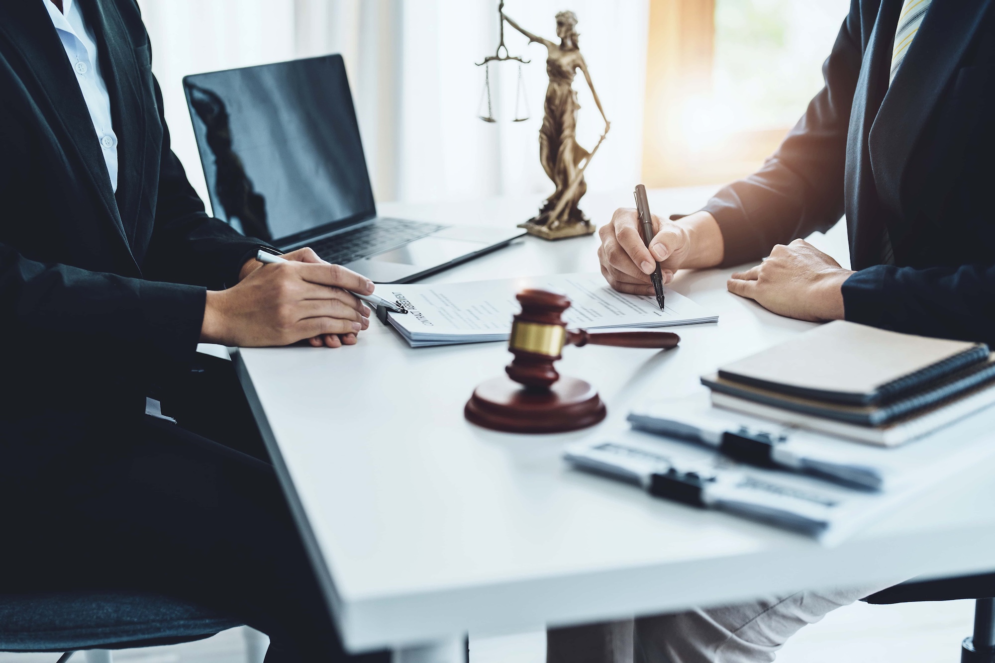Law Consultation Agreement Contract Attorney or Lawyer holding a pen is consulting with a client to explain the pattern of answering questions before going to court to decide a lawsuit