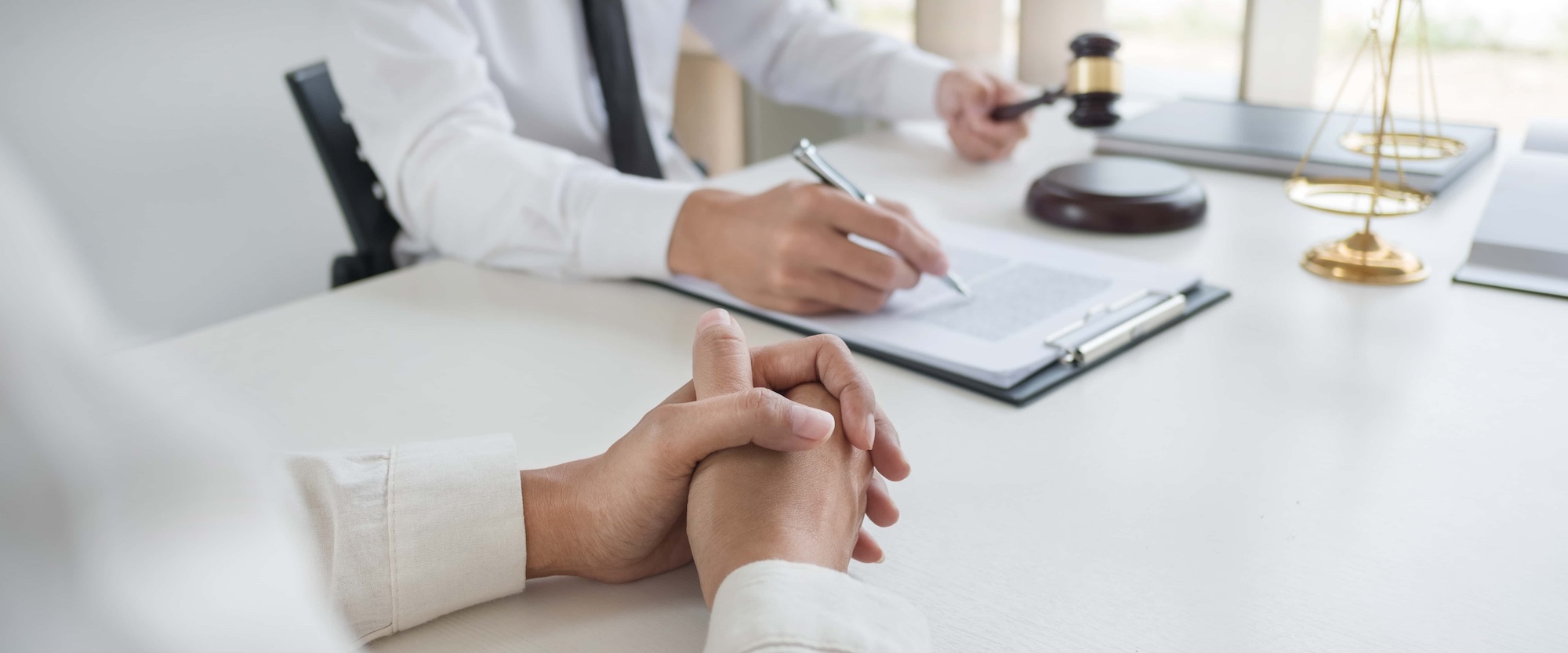 Lawyer preparing to sign a contract reading documents at meeting 1