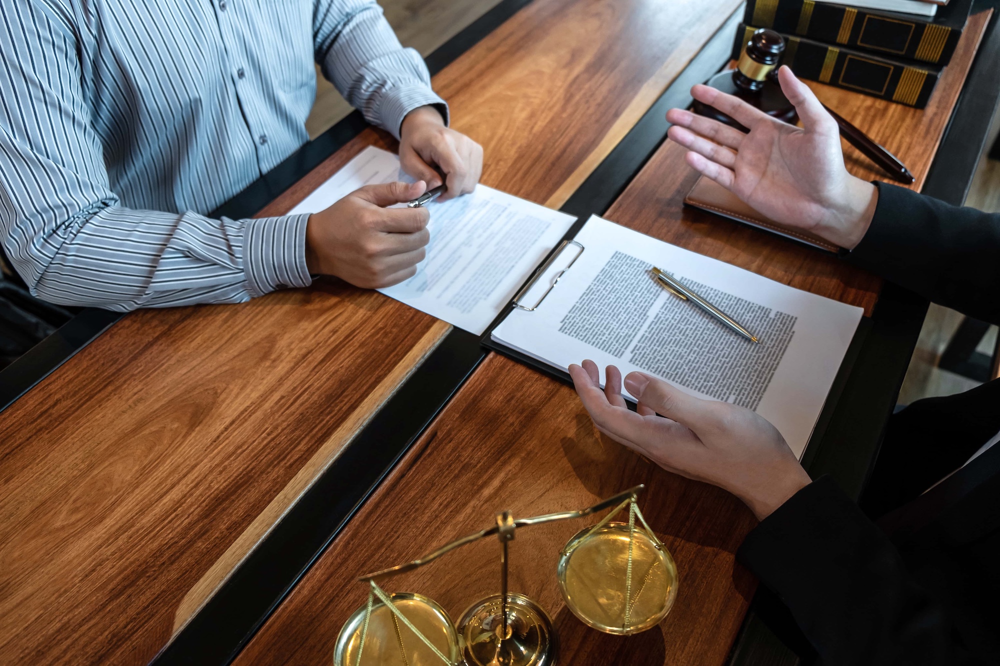 Male lawyer discussing negotiation legal case with client meeting with document contact in courtroom law and justice concept