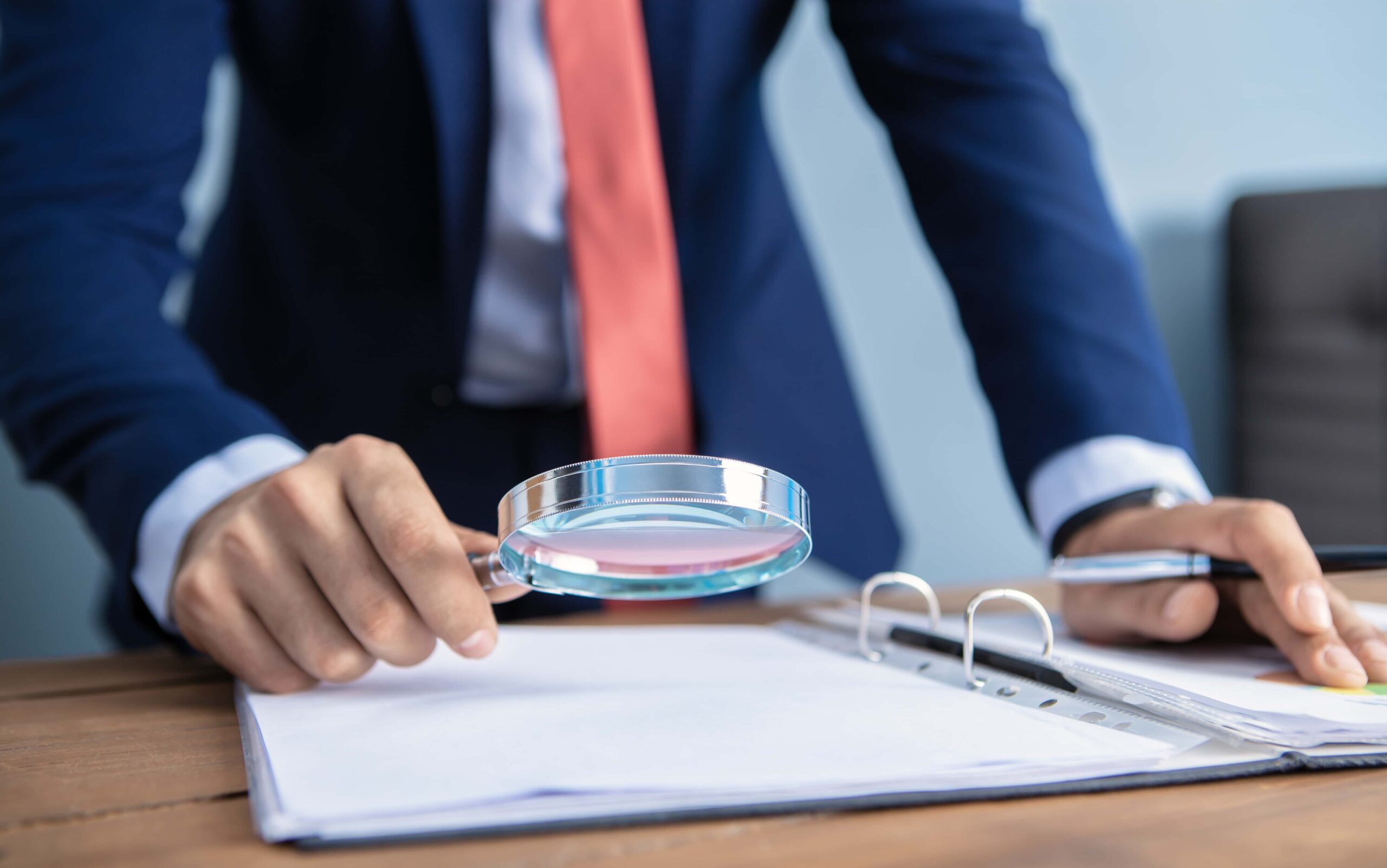 businessman looking with a magnifier scaled