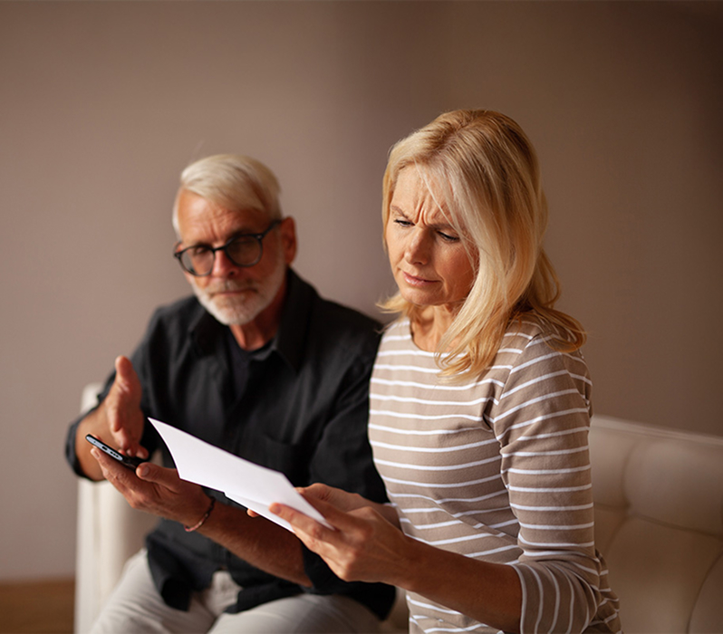 couple worryingly reviewing a document