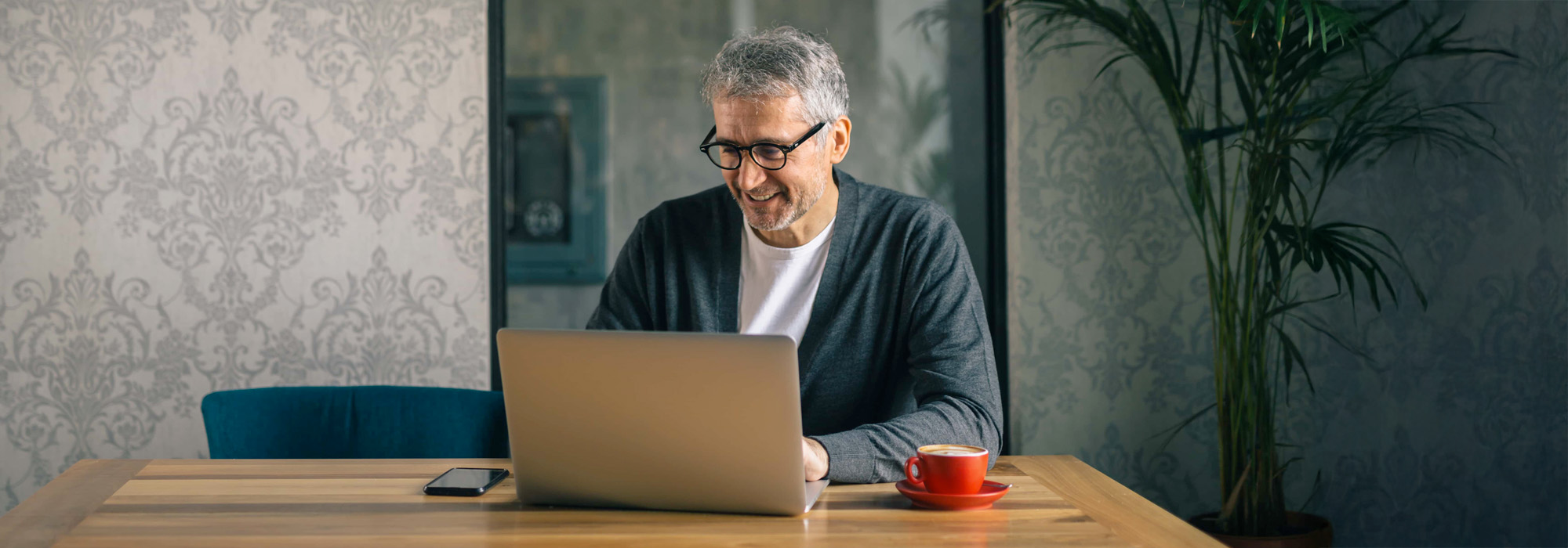 man using laptop in cafe bar