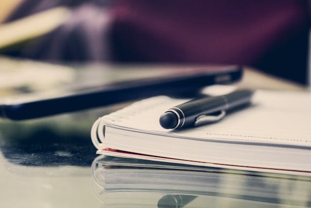notebook with a pen